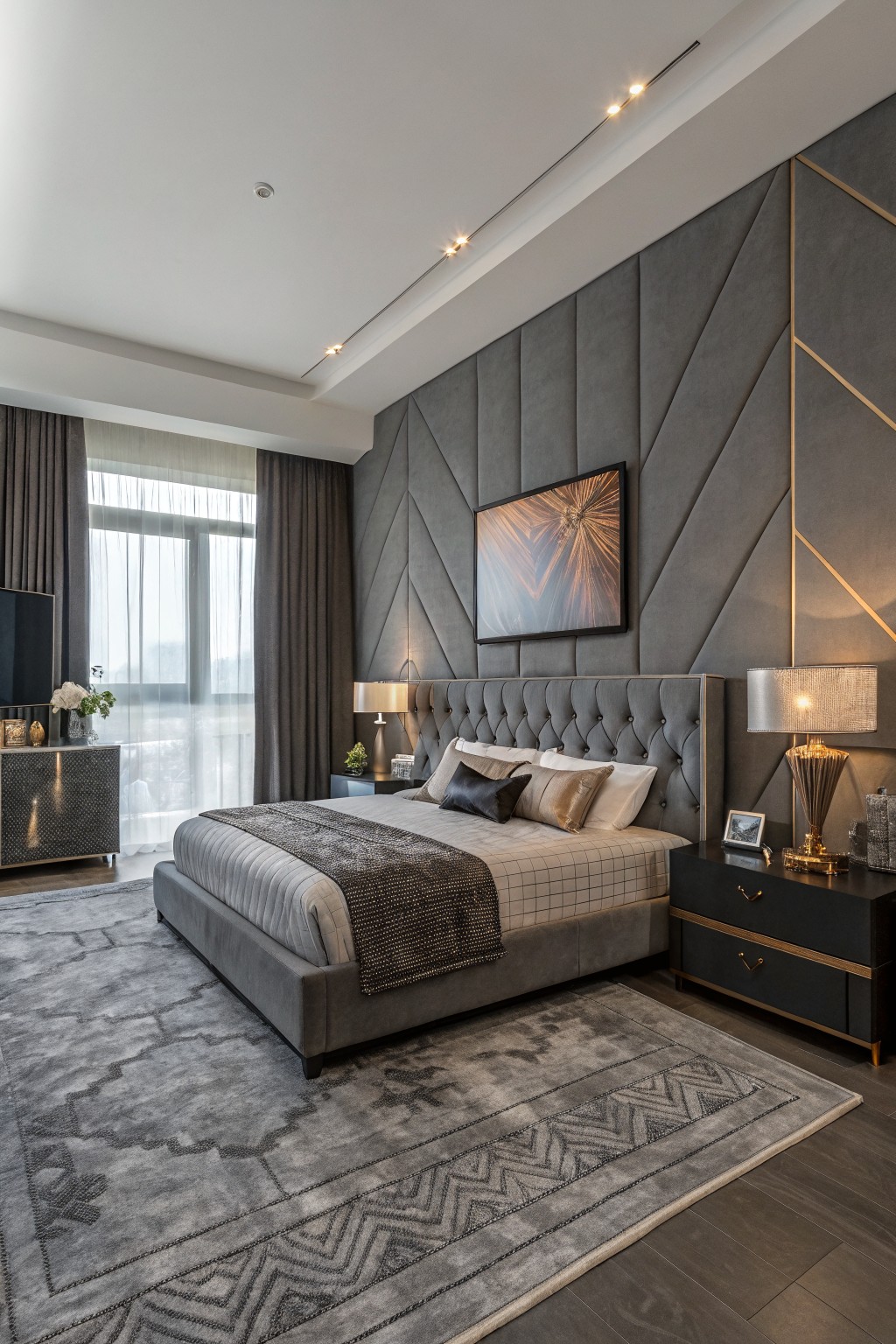 Modern bedroom with deep warm gray tufted accent wall, gold accents, gray bed, and city view windows