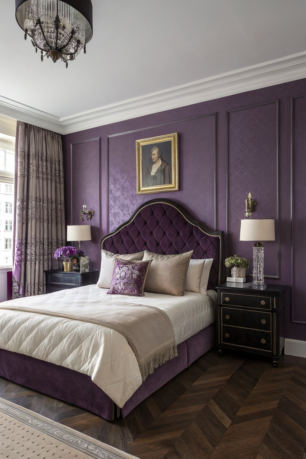 Bedroom interior with deep purple paneled walls, tufted purple velvet headboard, black wood nightstands, and herringbone floors