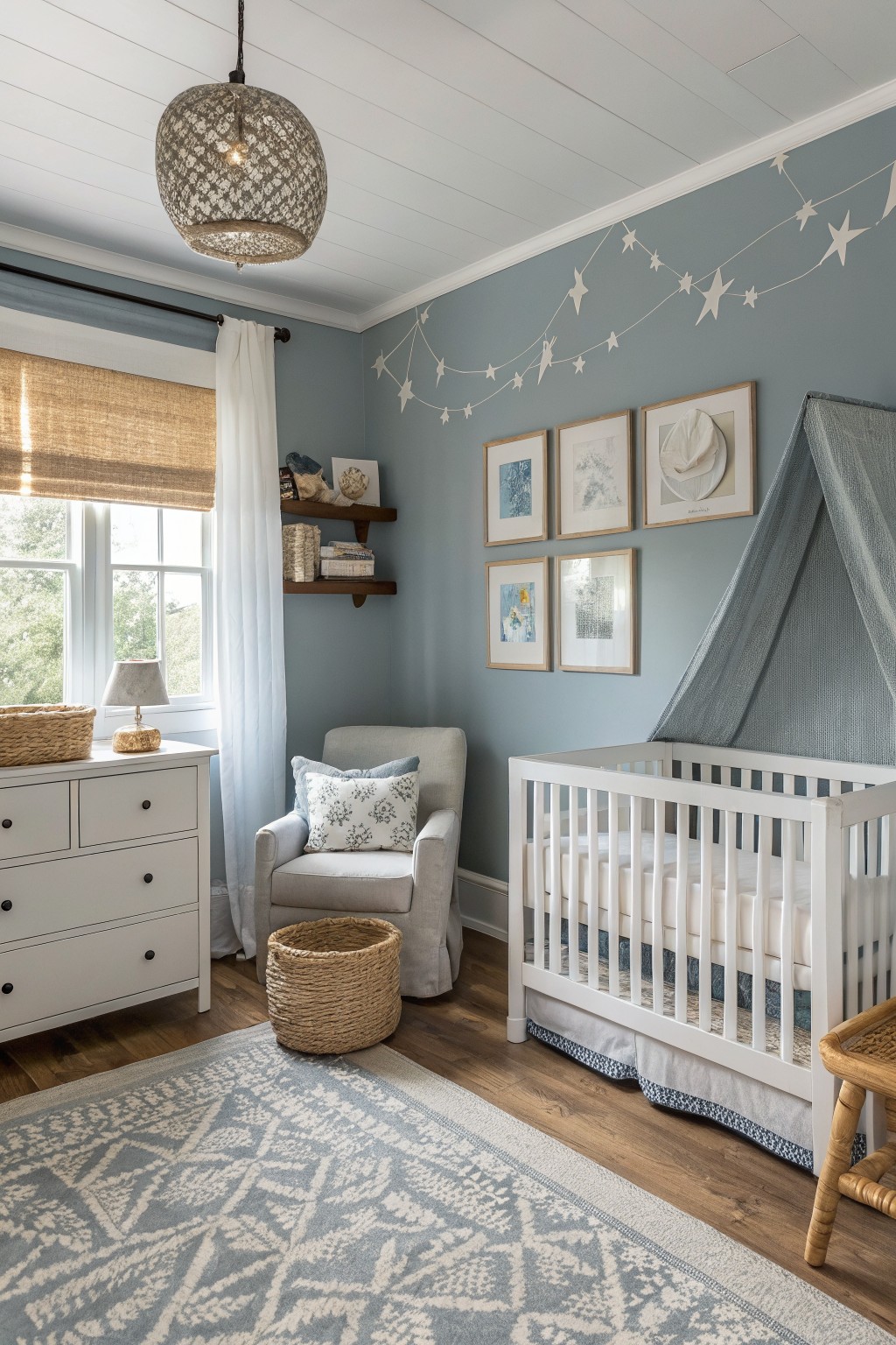 Cozy nursery with soft blue-gray walls, white crib under fabric canopy, glider chair, dresser, and hardwood floors