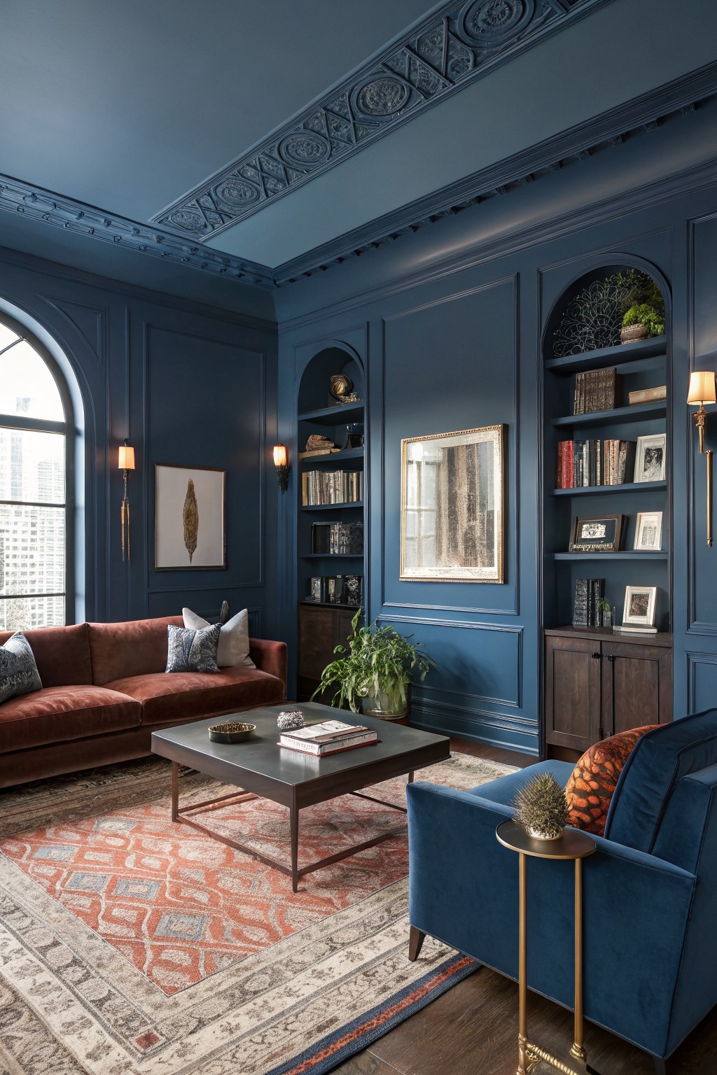 Elegant living room with deep navy paneled walls and ceiling, rust sofa, wood floors, and brass accents