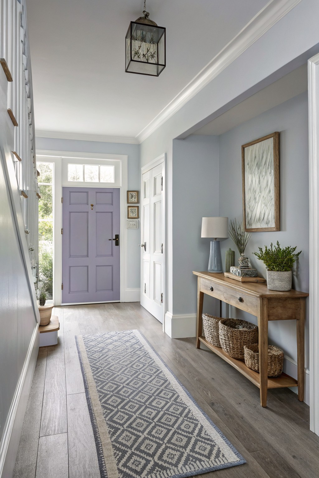 Light blue-gray walls in a cozy entry hallway with purple front door, wood side table, seagrass baskets, and gray runner rug
