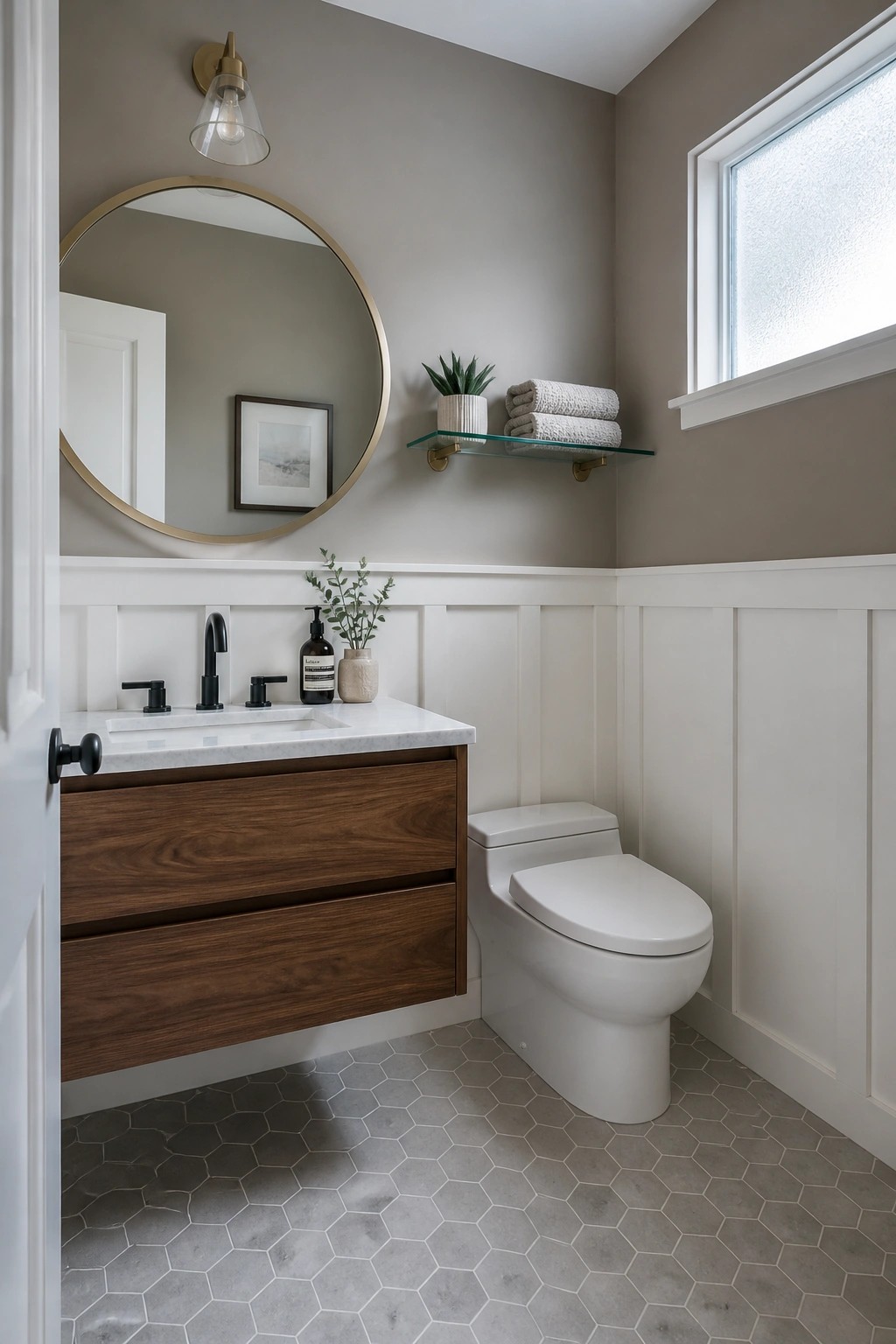 A bathroom with warm greige walls above white wainscoting.