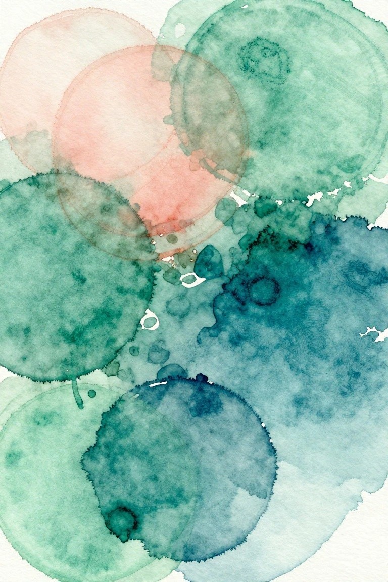 Abstract watercolor circles in green, teal, blue, and pink overlapping on white paper