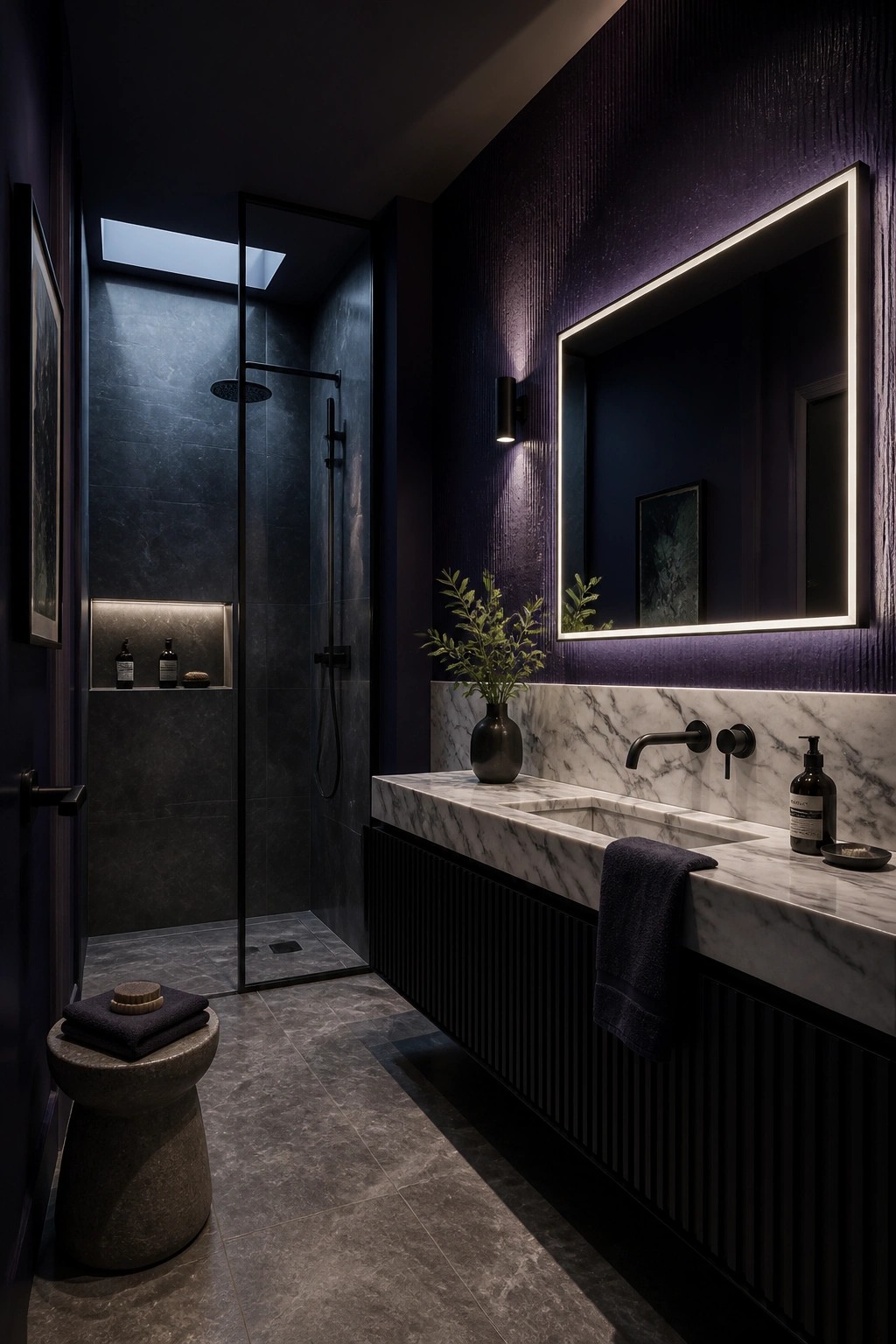 A bathroom featuring deep purple walls and a marble vanity.