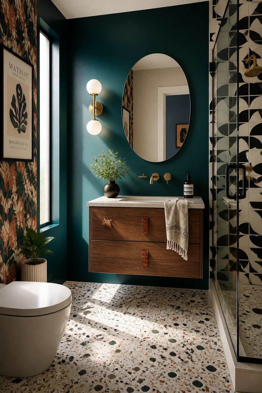 A bathroom with deep teal walls, a wood vanity, and a round mirror.