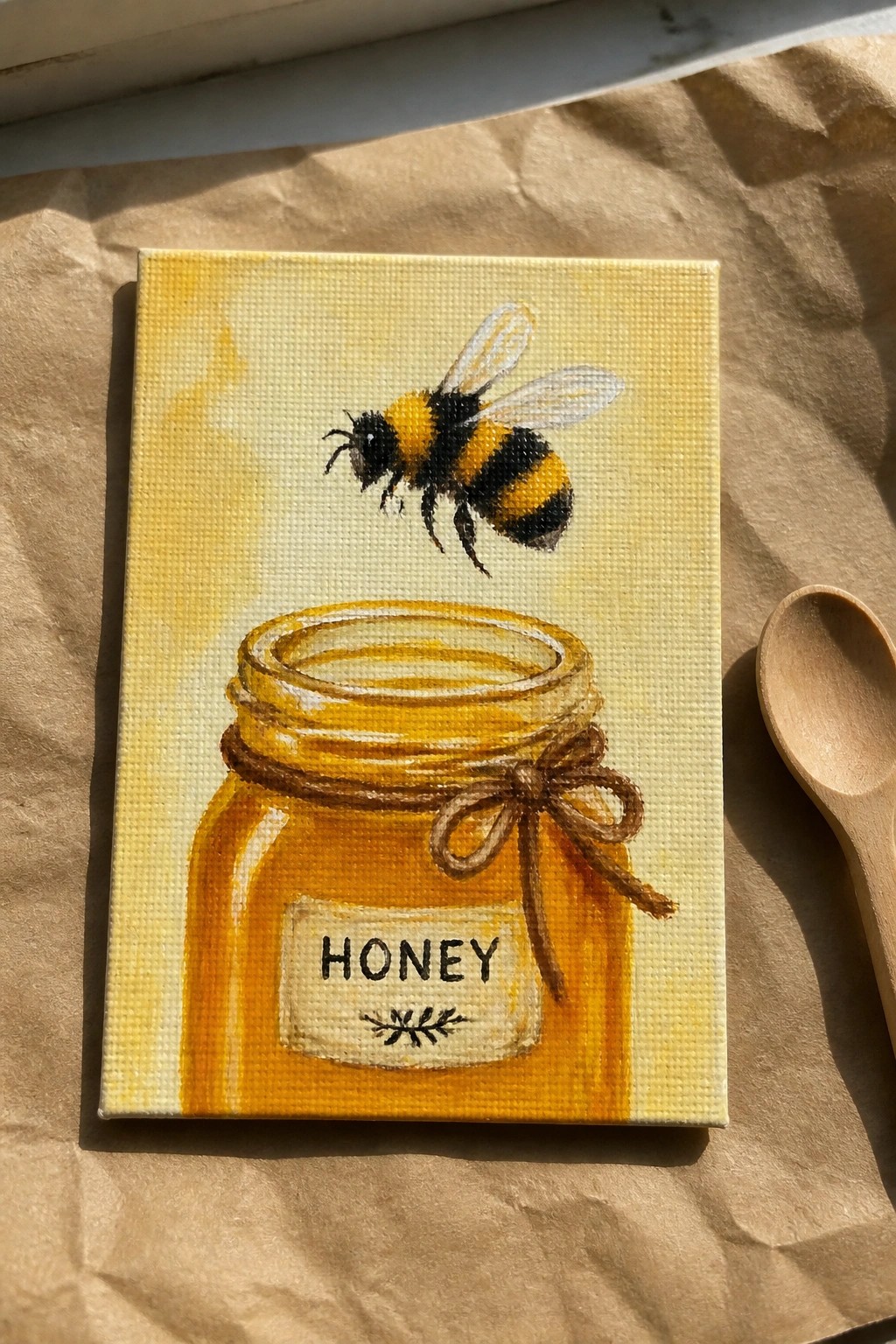 Canvas painting of bumblebee flying above honey jar with bow on brown paper