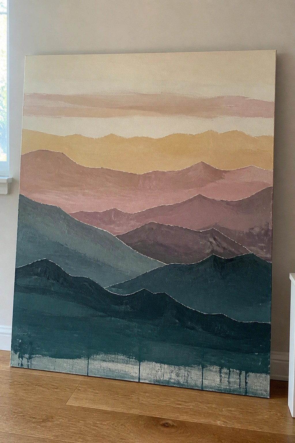 Layered abstract mountain painting in teal, pink, yellow, and beige on canvas.