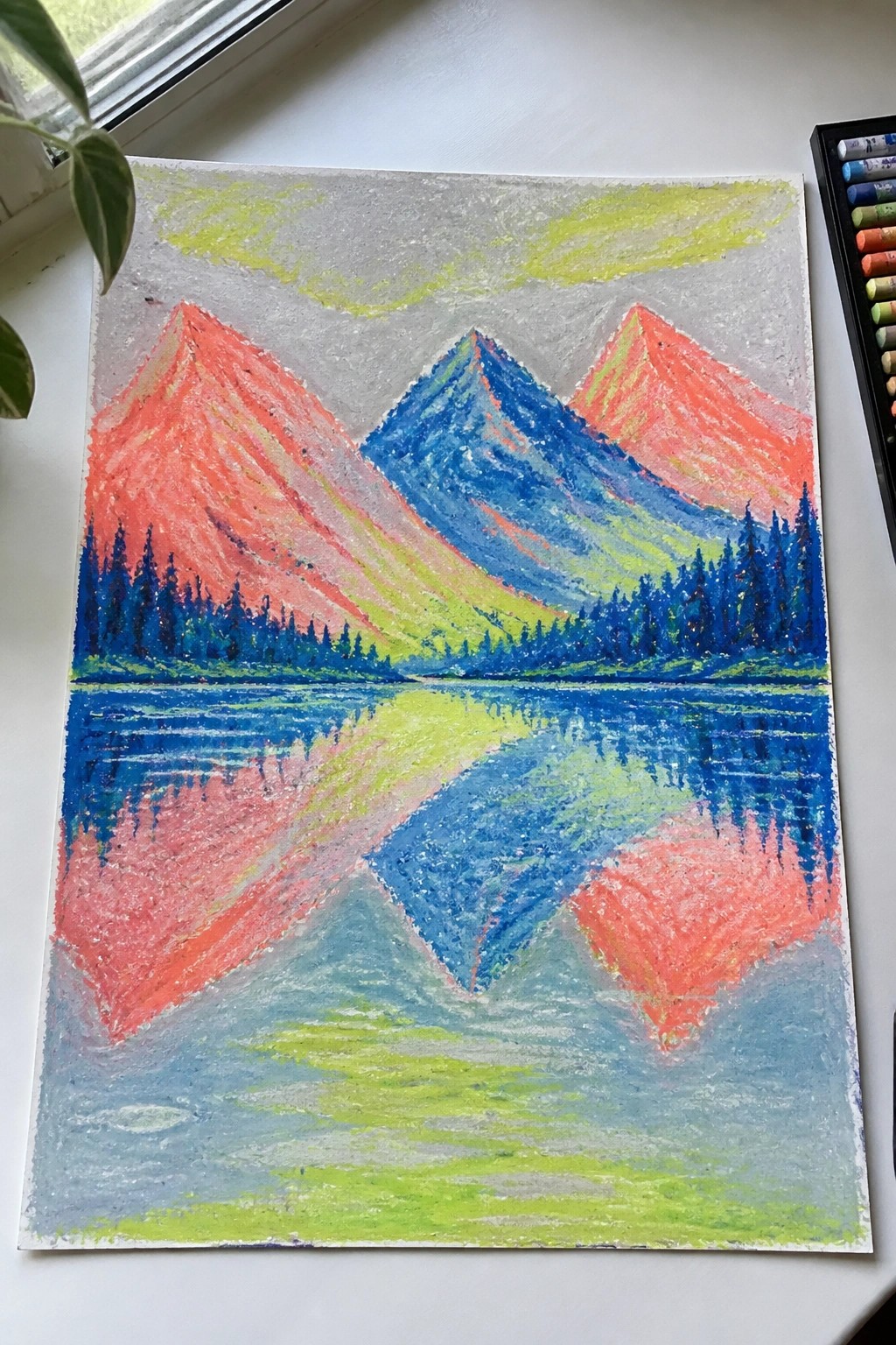 Vibrant pastel drawing of red and blue mountains reflected in a lake