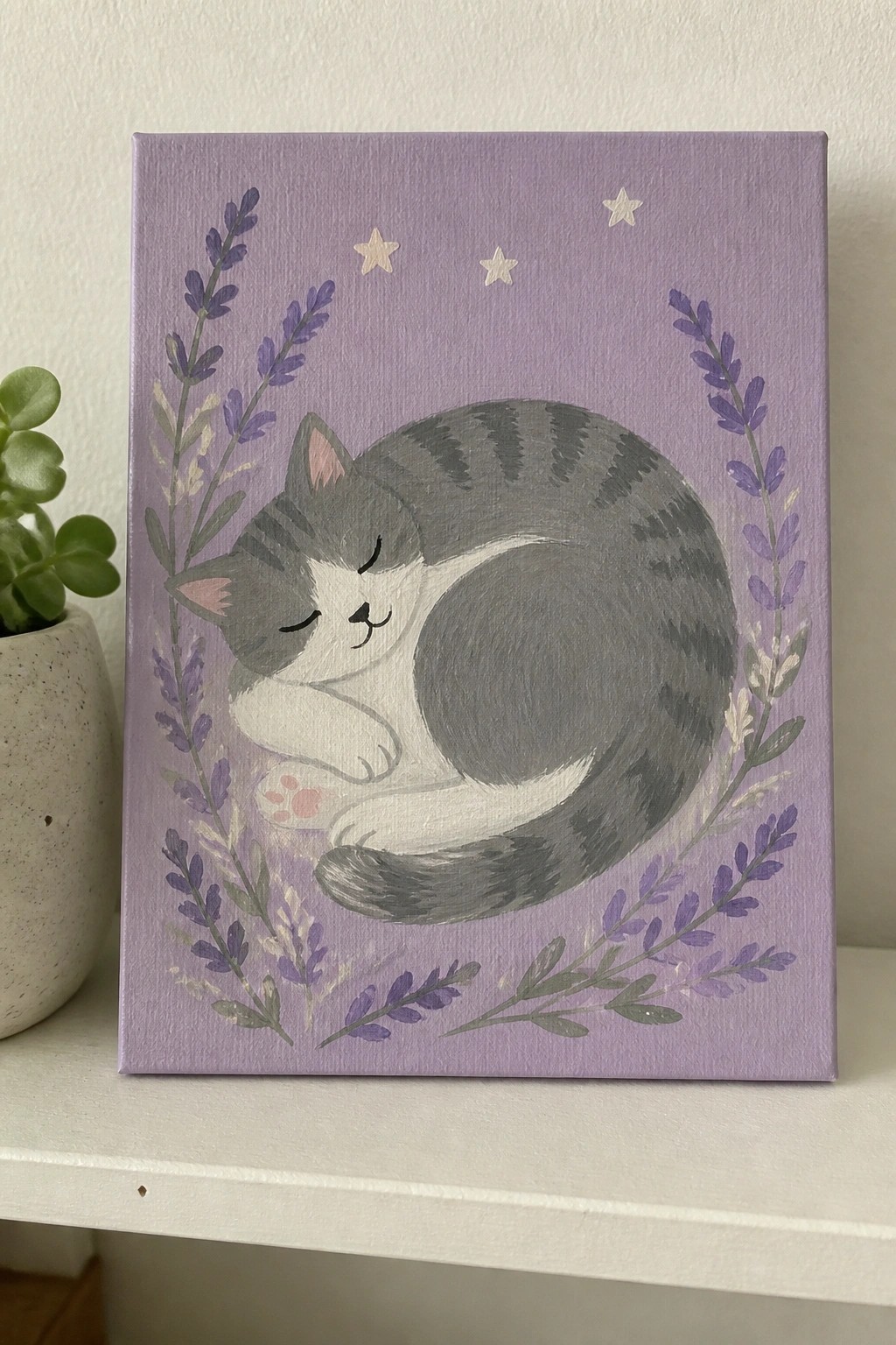 Curled gray and white cat sleeping on purple canvas amid lavender sprigs and stars