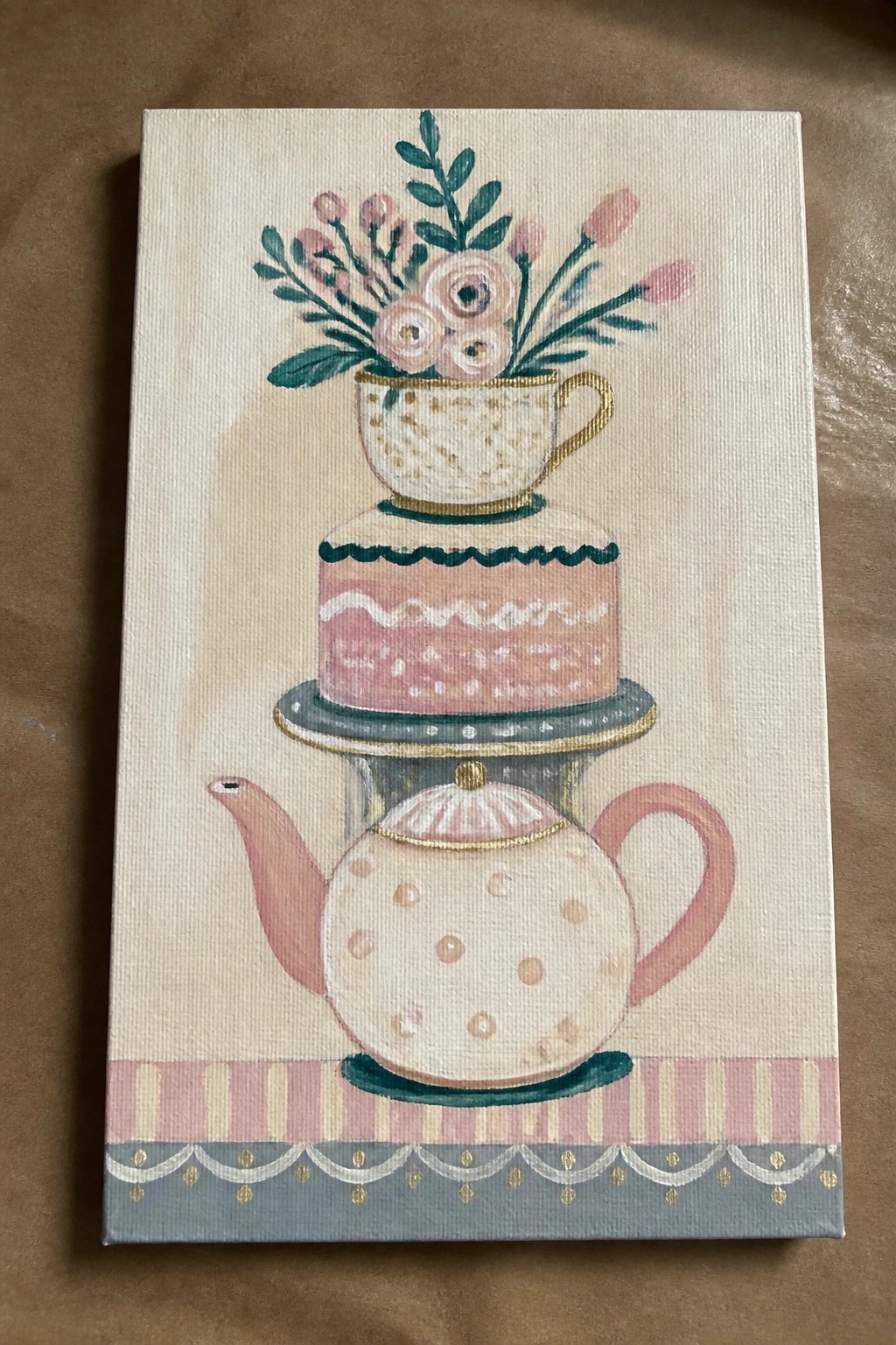 Pastel painting of stacked polka-dot teapot, pink cake, and floral teacup.