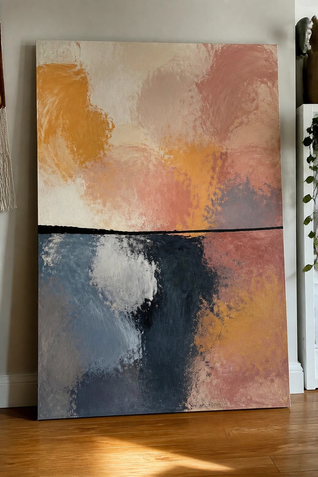 Large abstract painting split by black line into warm orange-pink and cool blue-gray fields