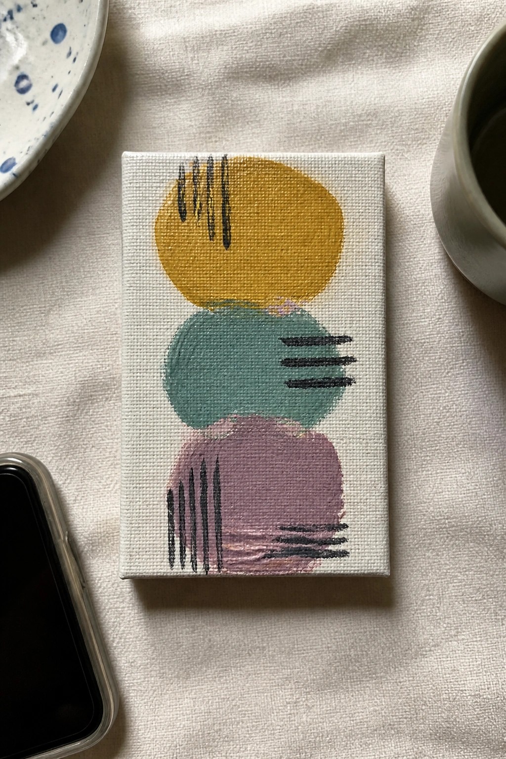 Abstract painting with stacked yellow, teal, and purple shapes plus black lines on canvas.