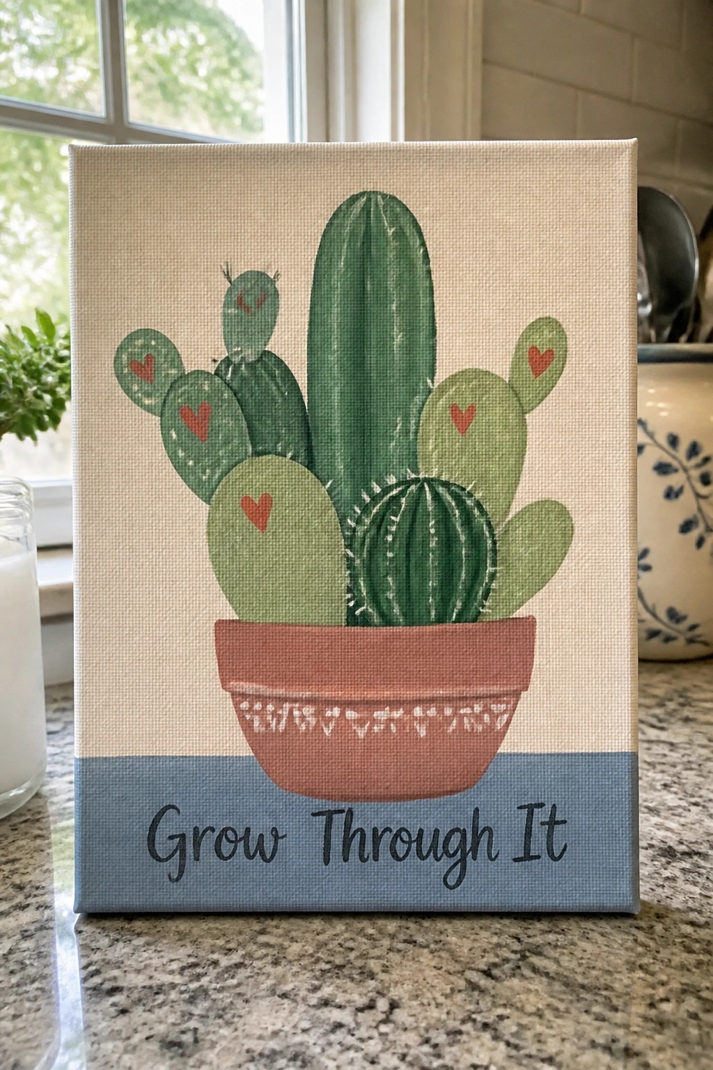 Canvas with colorful cacti in terracotta pot, red hearts, and