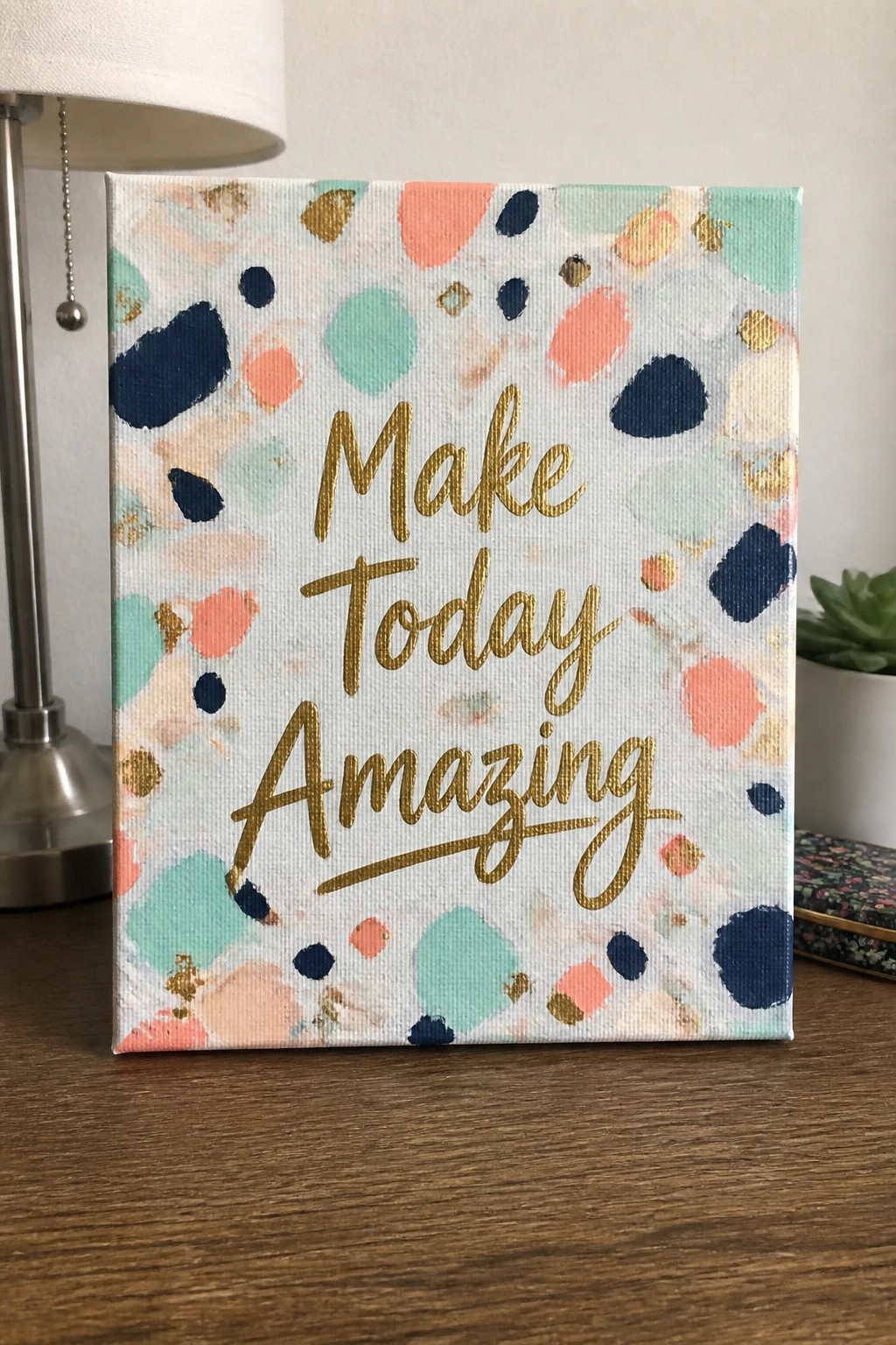 Colorful polka-dotted canvas with gold text