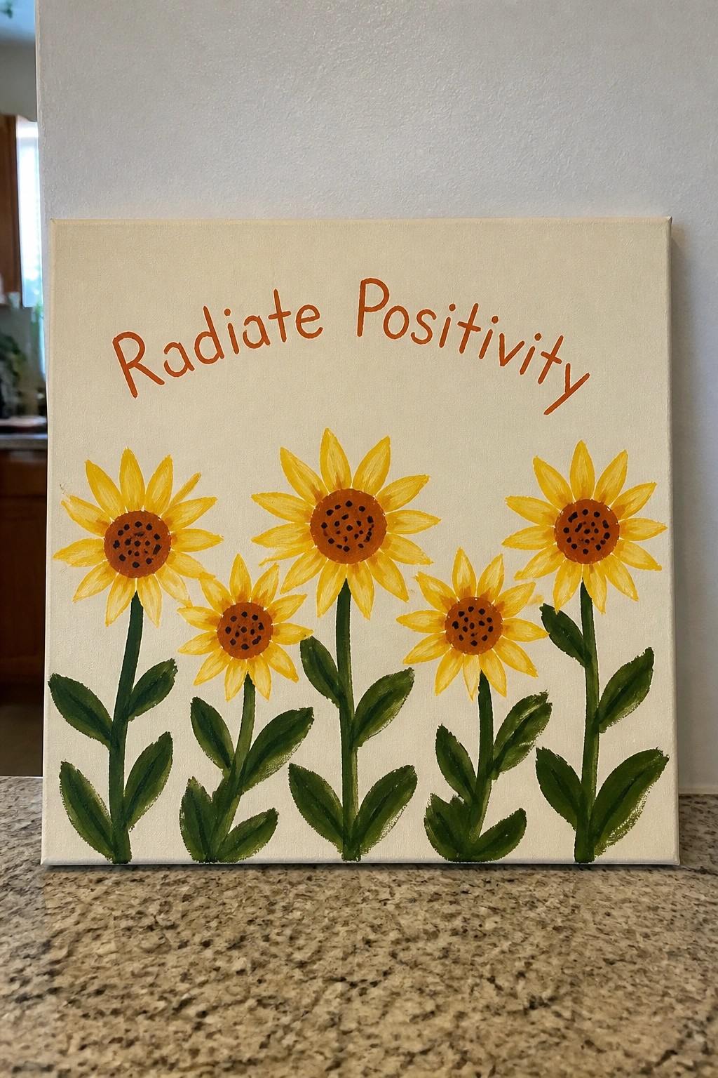 Canvas painting of five yellow sunflowers below orange