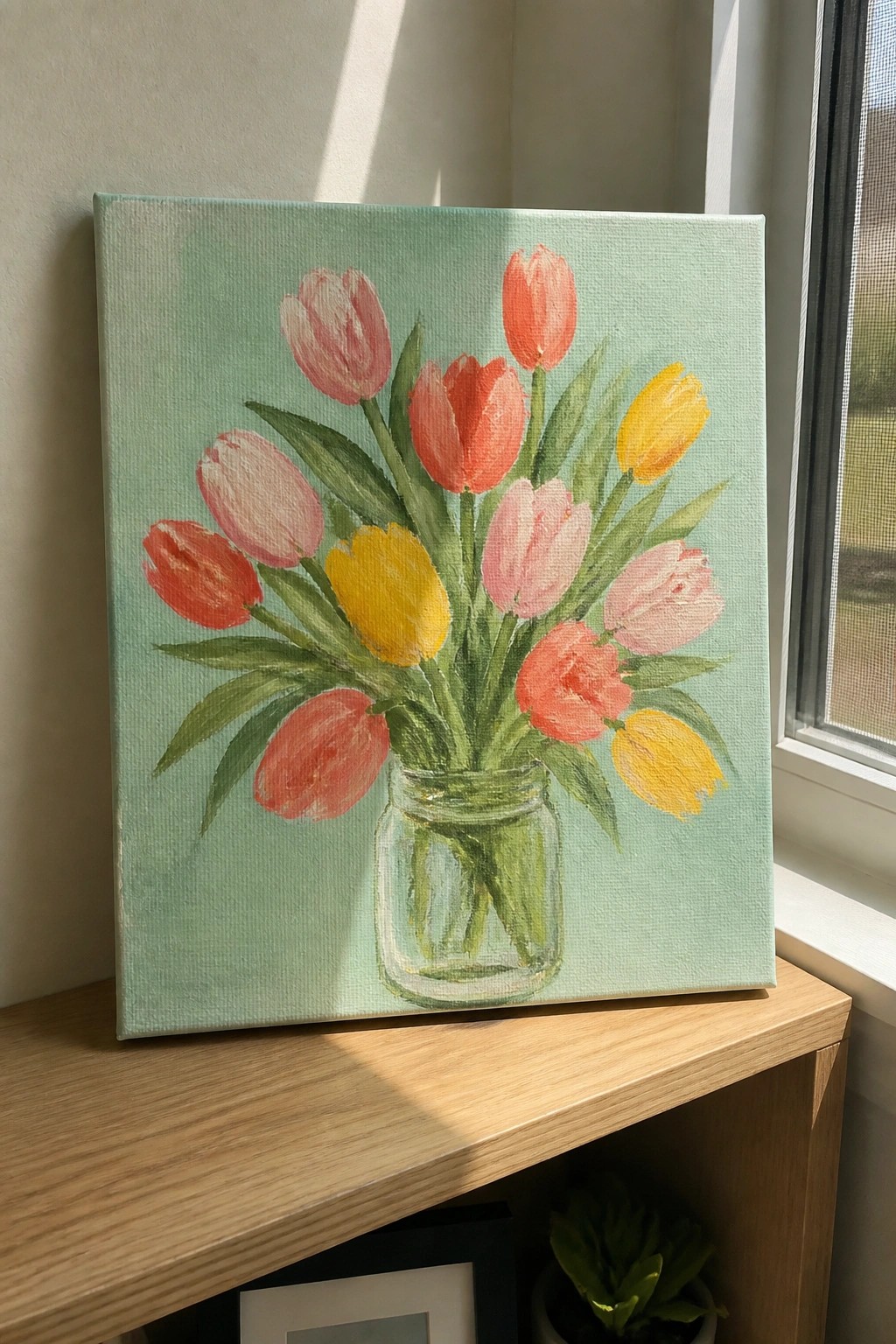 Colorful tulips in glass jar painted on light green canvas on wooden shelf