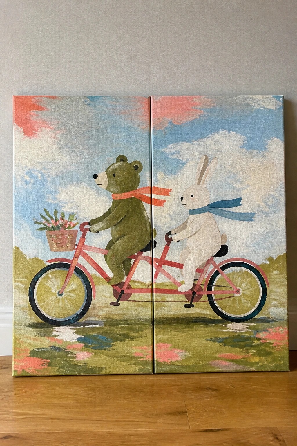 Bear with red scarf and rabbit with blue scarf on pink tandem bike