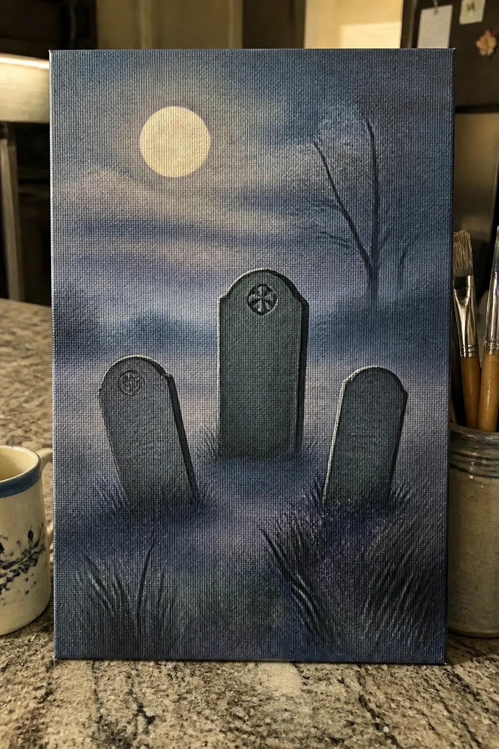 Three tombstones under a full moon in a misty blue graveyard painting.