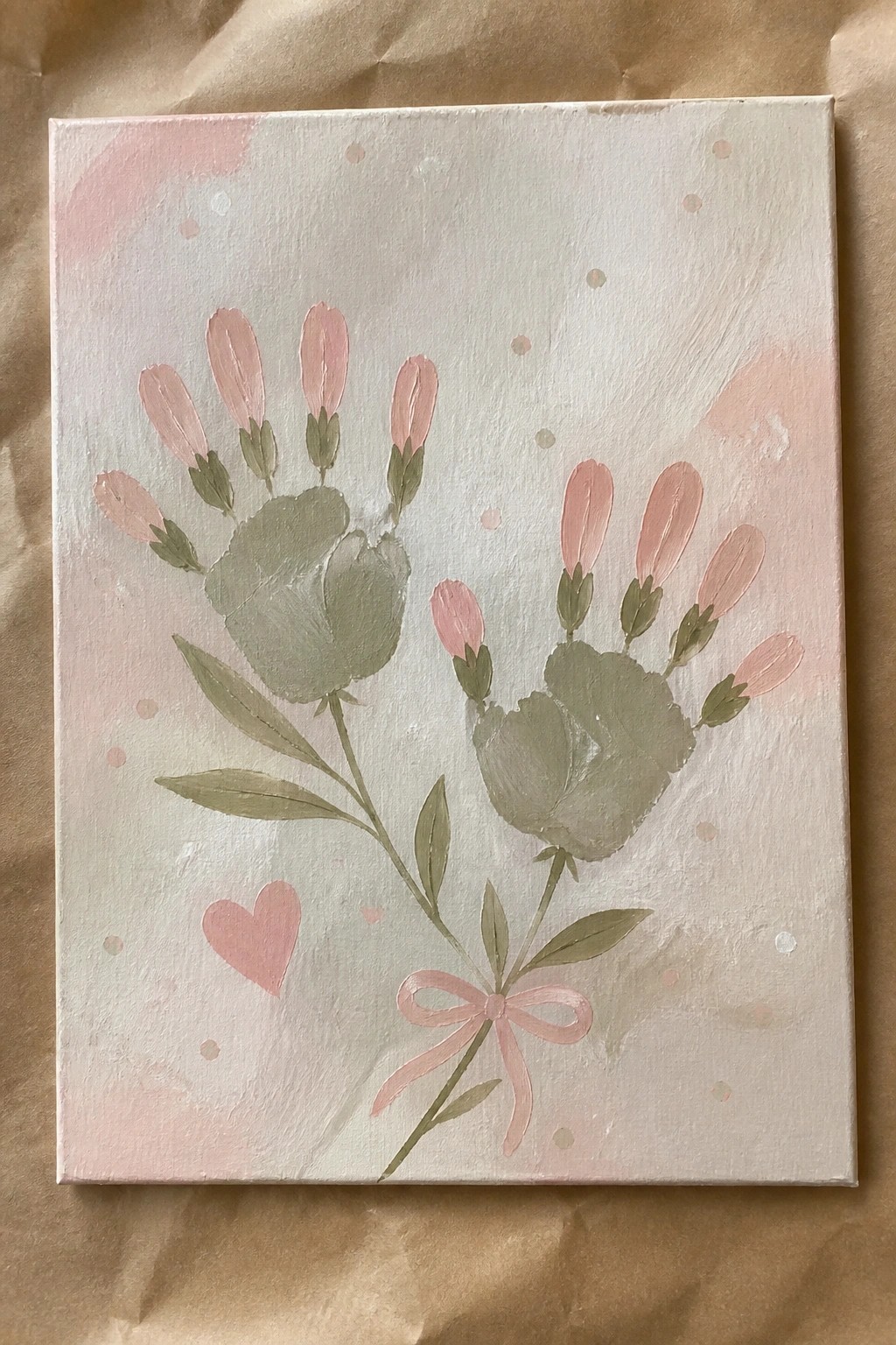 Pastel canvas with two handprint flowers, pink petals, bow, heart, and dots.