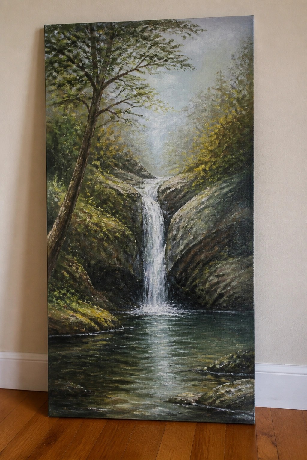 Large oil painting of waterfall cascading into pool amid rocky green cliffs.