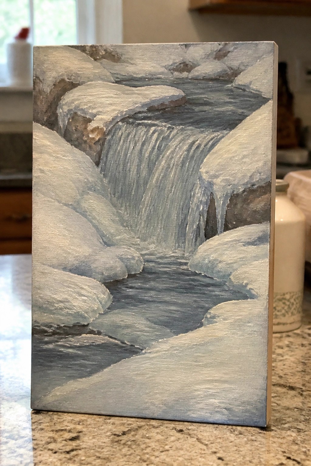 Winter painting of a cascading waterfall amid snow-covered rocks and icicles.
