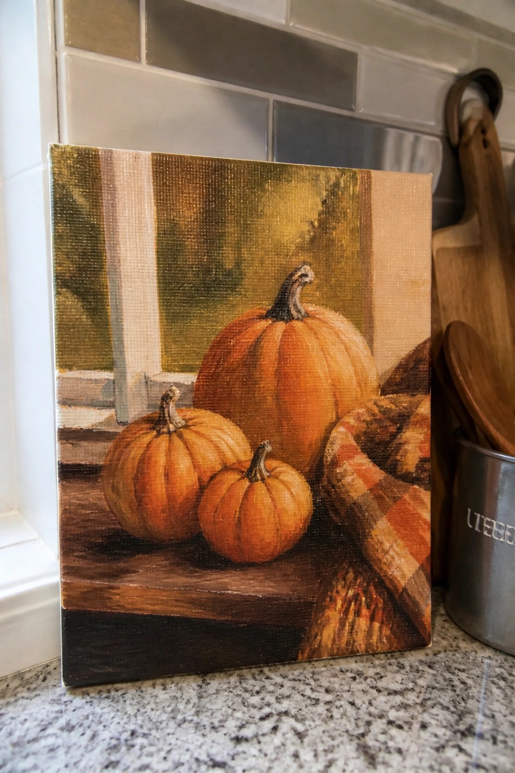 Three orange pumpkins and plaid fabric on a wooden windowsill in a painting.