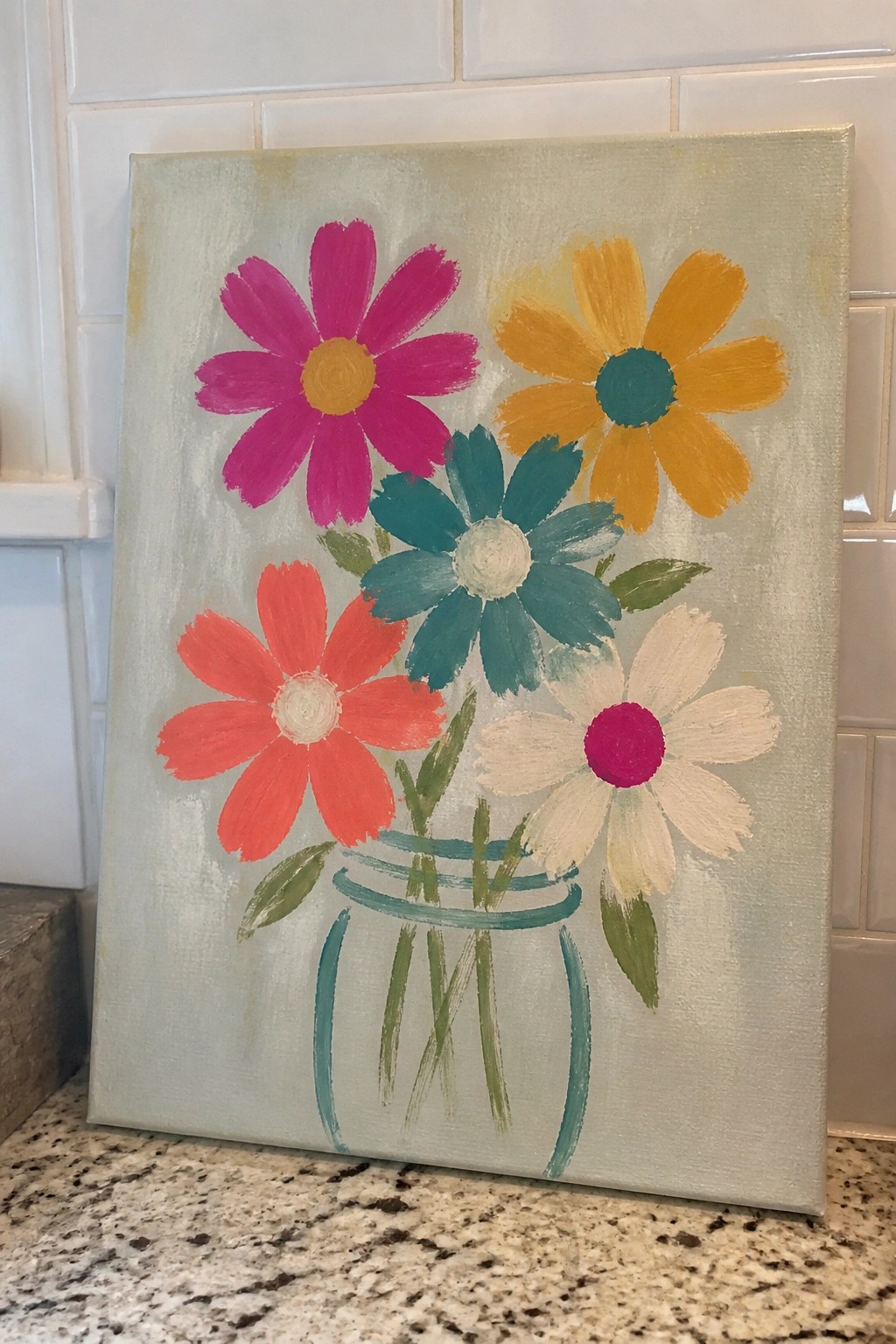Colorful abstract painting of five flowers in a teal jar on canvas