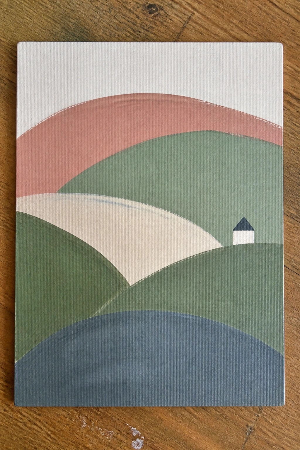 Abstract painting of layered curved hills in green, pink, and blue with a small house.