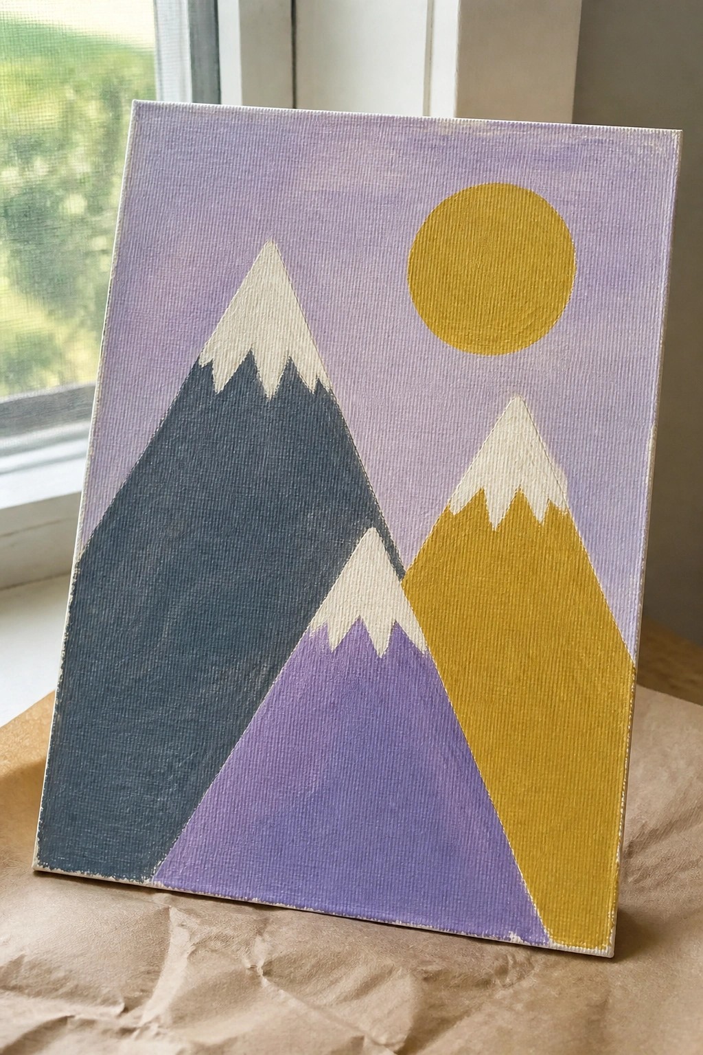 Abstract painting of snow-capped mountains in blue, purple, and yellow with golden sun on lavender background