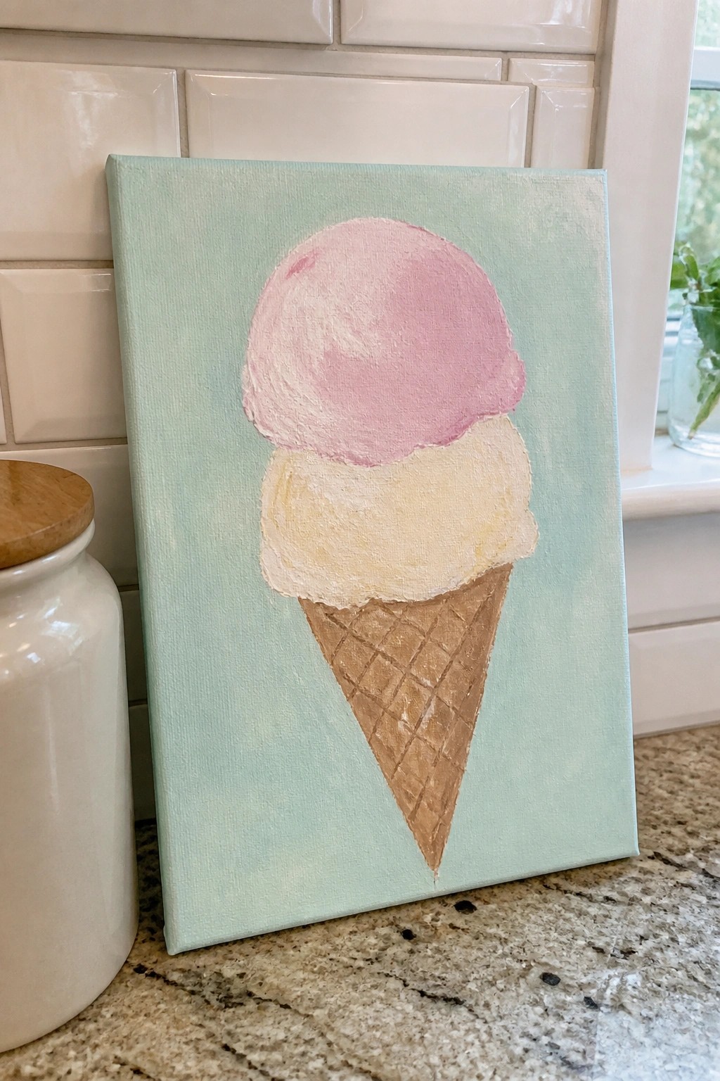 Hand-painted pink and beige ice cream cone on mint green canvas in kitchen
