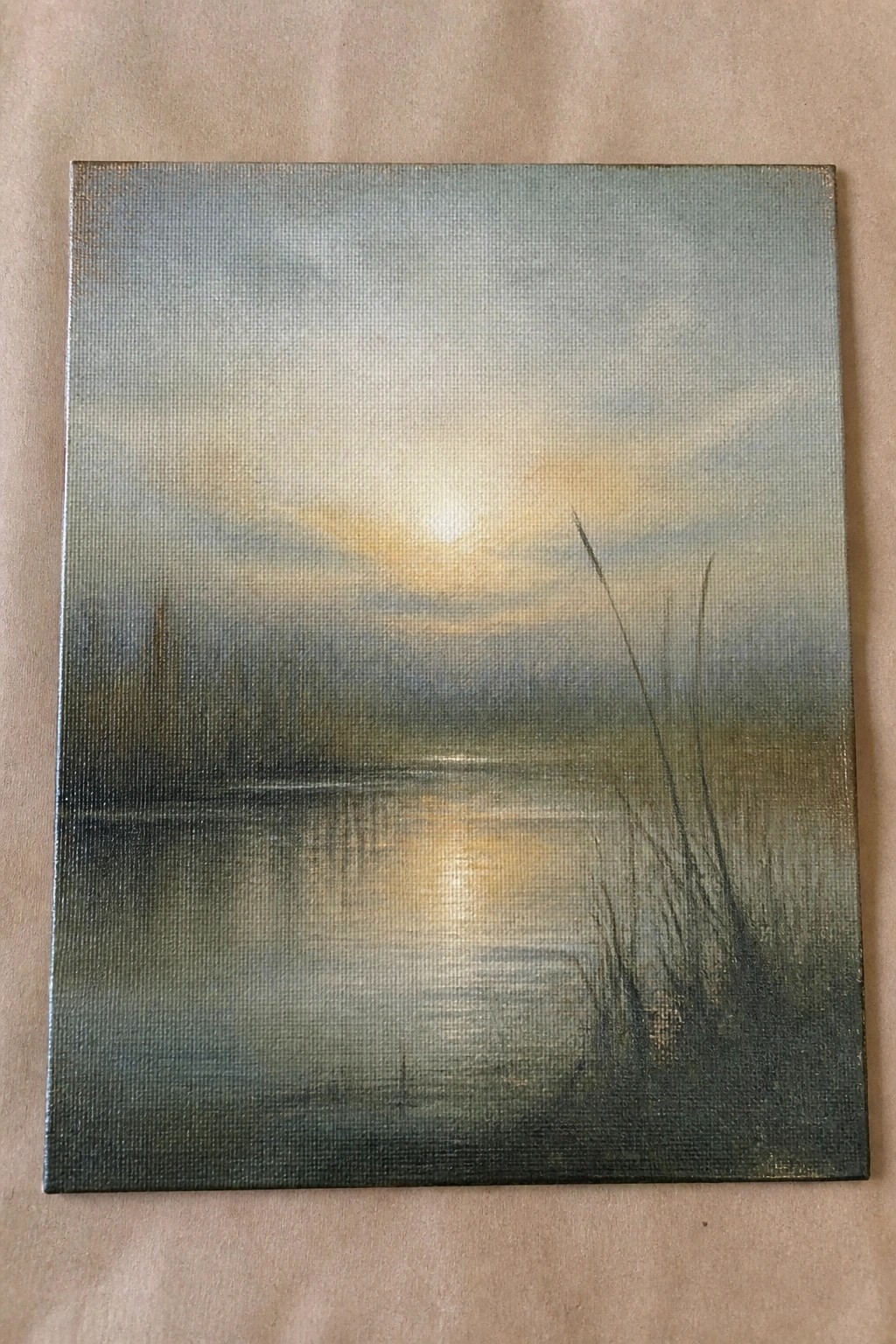 Misty landscape painting of golden sun reflecting on calm water with reeds.