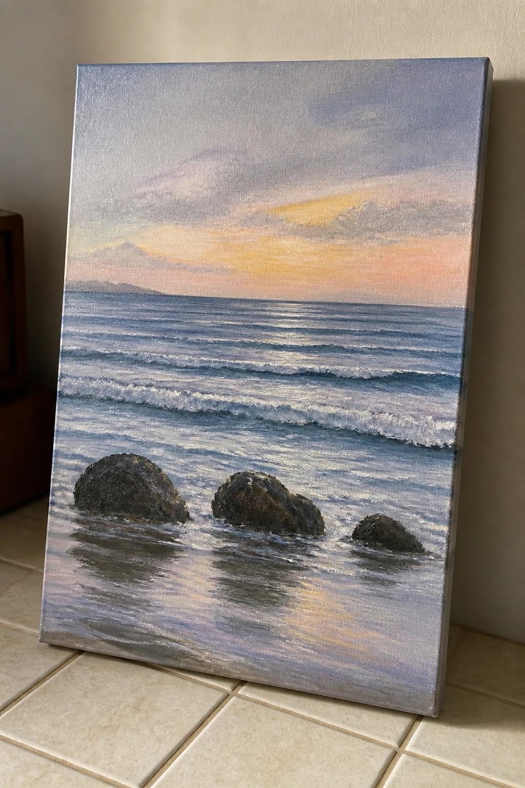 Oil painting of ocean waves and dark rocks under a colorful sunset sky