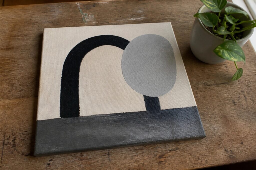 19 Chic Black And White Acrylic Painting Ideas For A Timeless Statement Minimalist abstract painting with black arch, gray circle, and horizontal line on canvas
