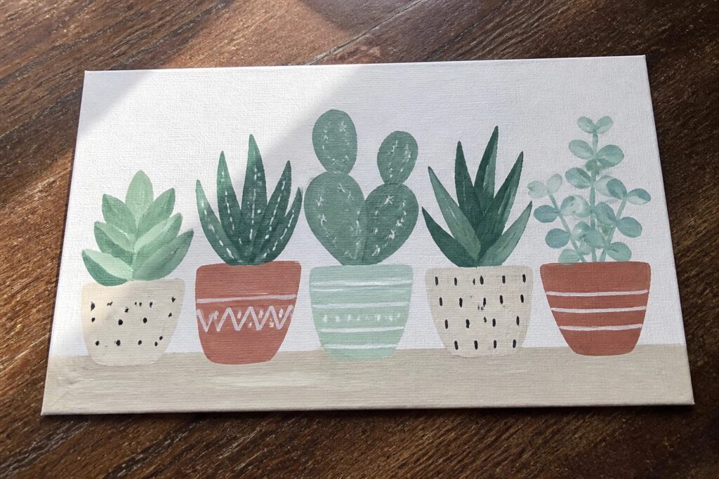 19 Clever Canvas Painting Ideas Without Advanced Drawing Skills Five succulents in patterned pots on white canvas over wood