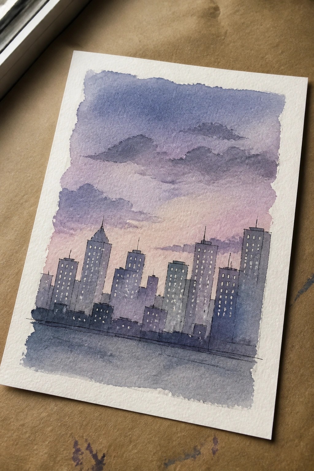 Watercolor city skyline with tall buildings under purple-pink clouds at dusk