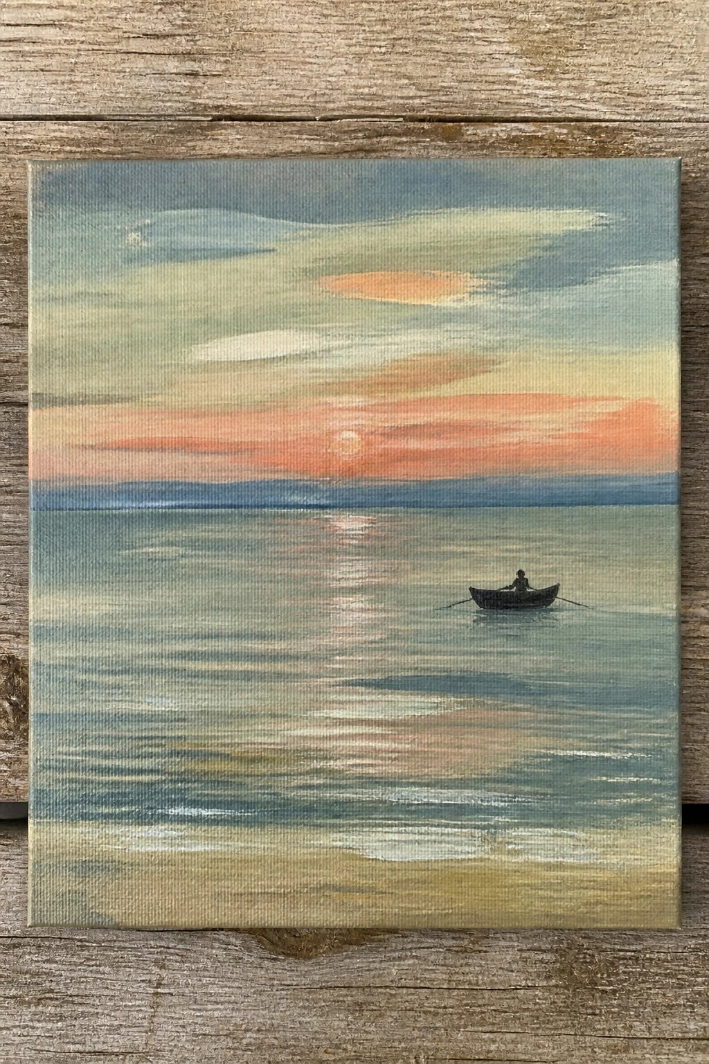 Painting of silhouetted rower in boat on calm sea under orange sunset sky