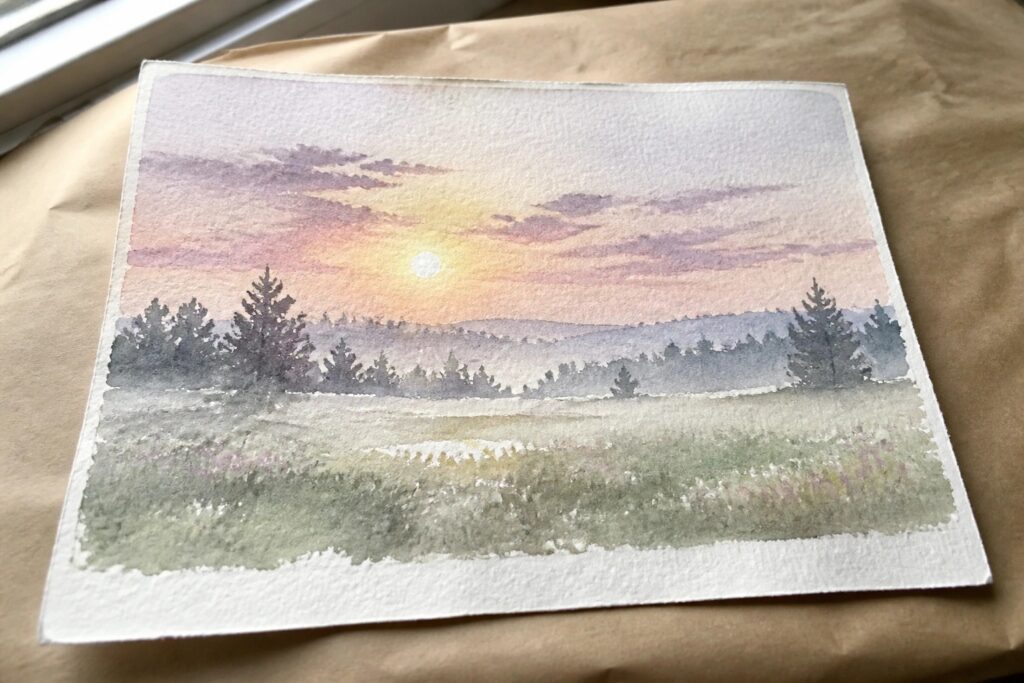 Watercolor sunset landscape with purple-pink clouds over misty hills and silhouetted trees.