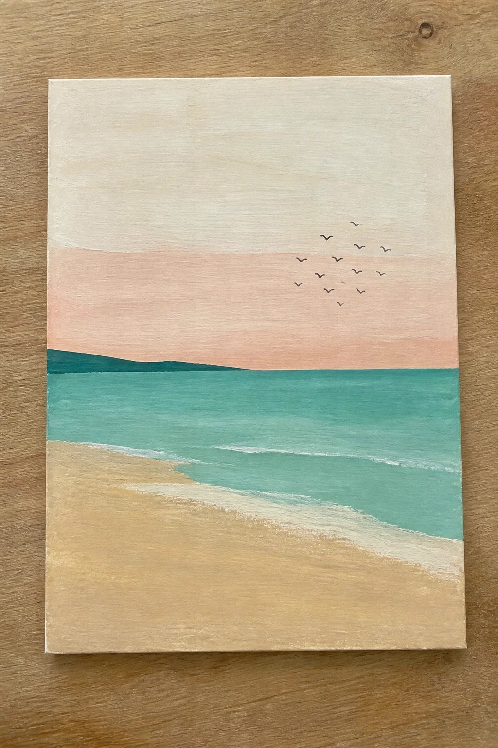 Minimalist beach painting with turquoise waves, sandy shore, pink sky, and distant birds.