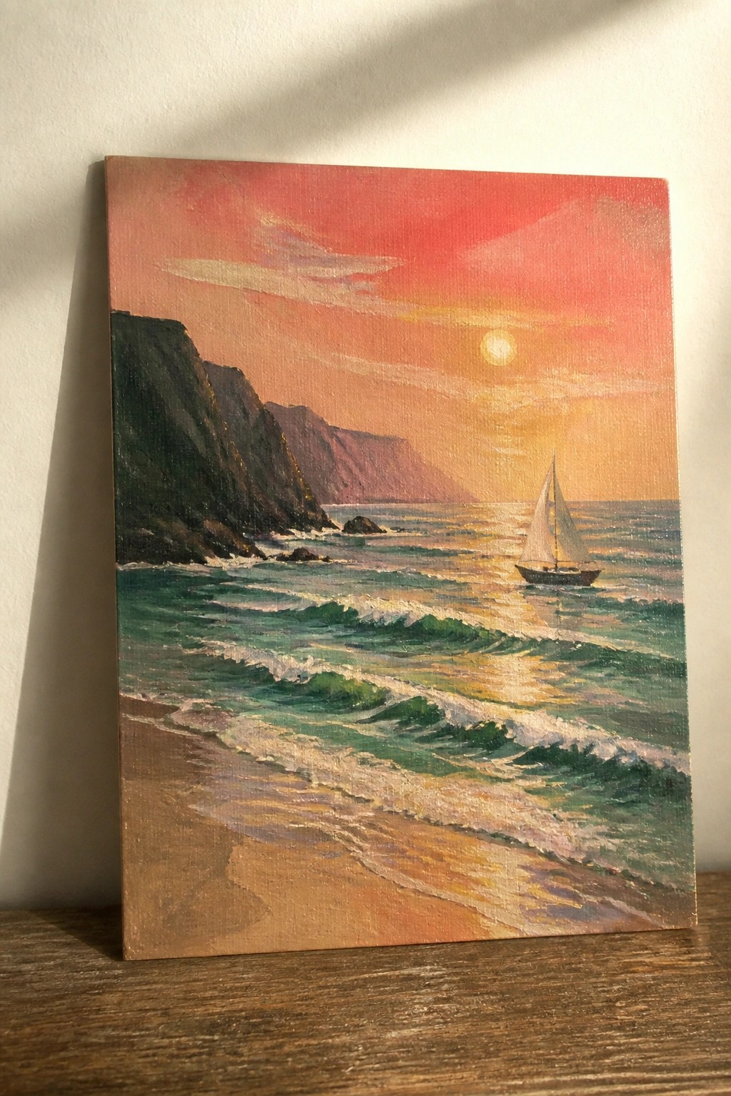 Sunset seascape painting with sailboat near cliffs and green waves on beach