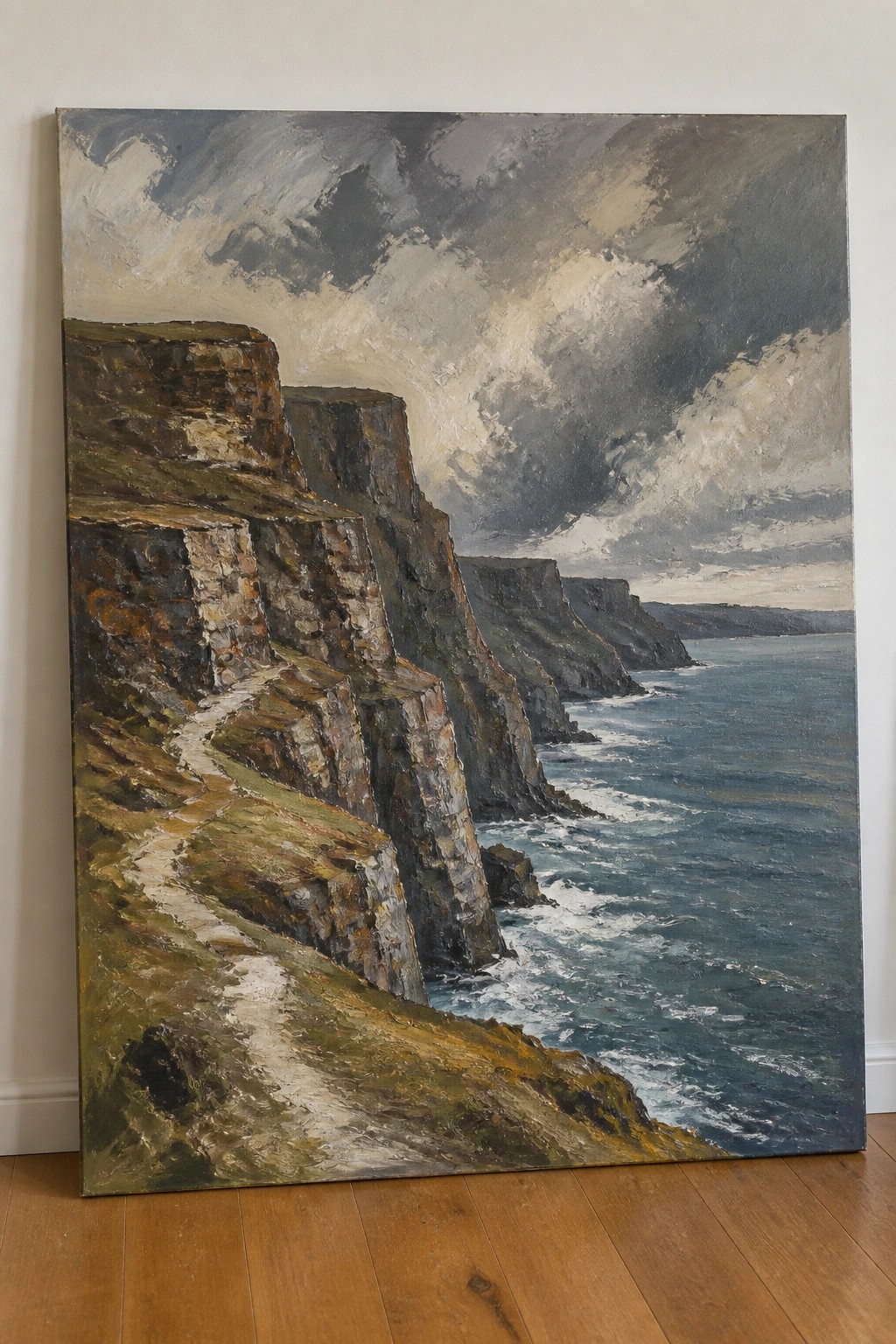 Dramatic oil painting of steep cliffs with winding path beside a stormy blue sea.