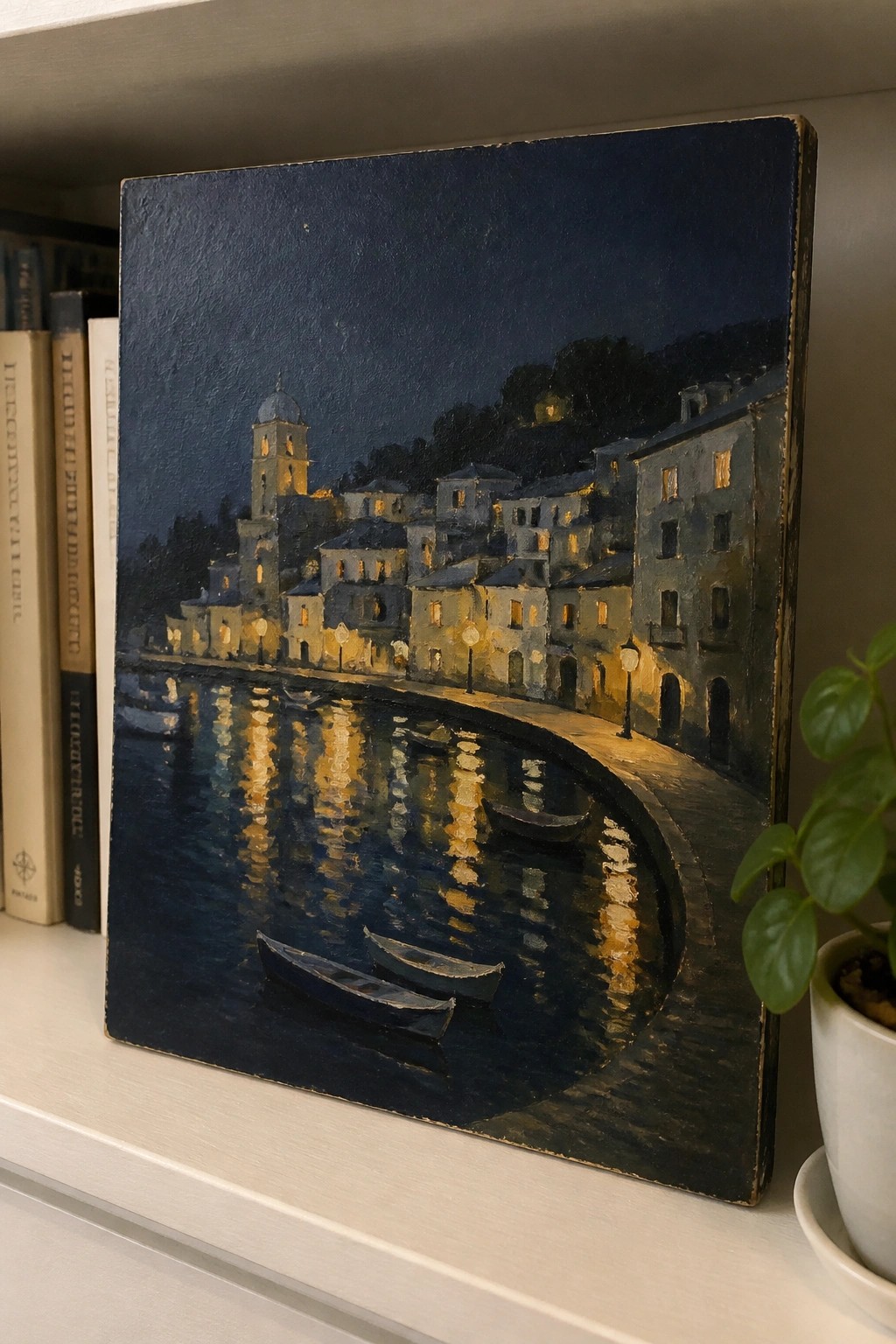 A realistic oil painting of a nighttime coastal town with illuminated buildings, a tower, boats on reflective water, and a dark sky.