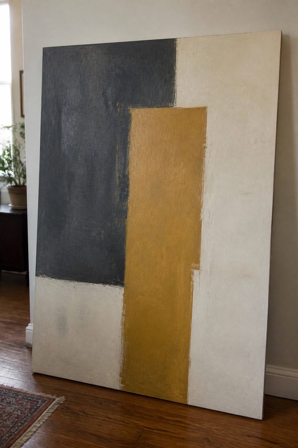 Large abstract oil painting with dark gray top-left block, vertical mustard yellow center band, and off-white areas on the right and bottom.