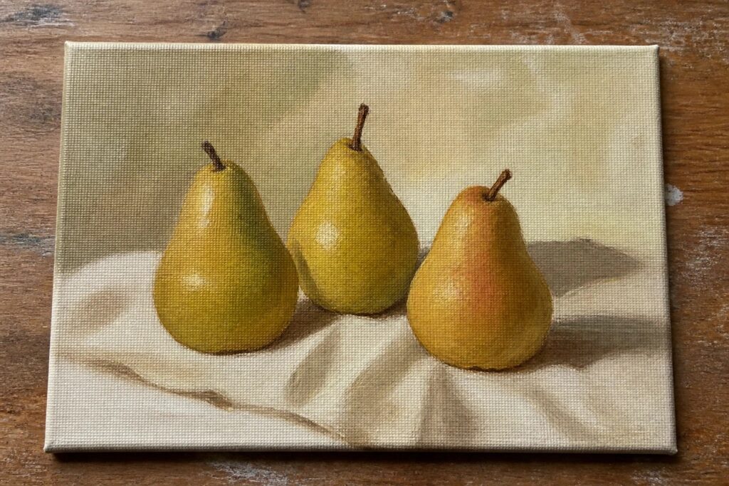 19 Effortless Oil Painting Ideas For Beginners To Start With Confidence Three green pears on white draped cloth atop wooden surface in oil painting