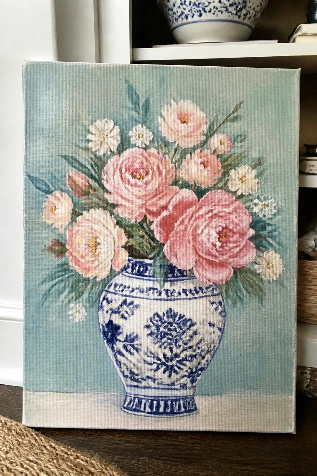 Pink peonies and white flowers in an ornate blue and white vase on canvas