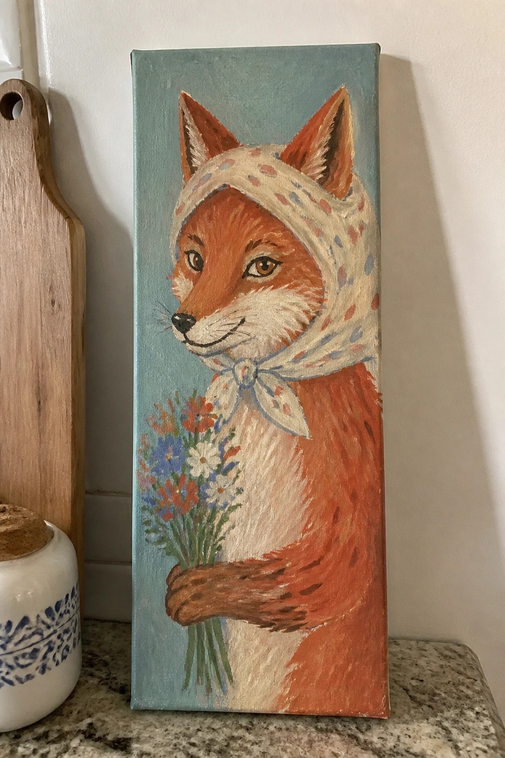 Orange fox in polka-dot headscarf holds wildflower bouquet on teal canvas.