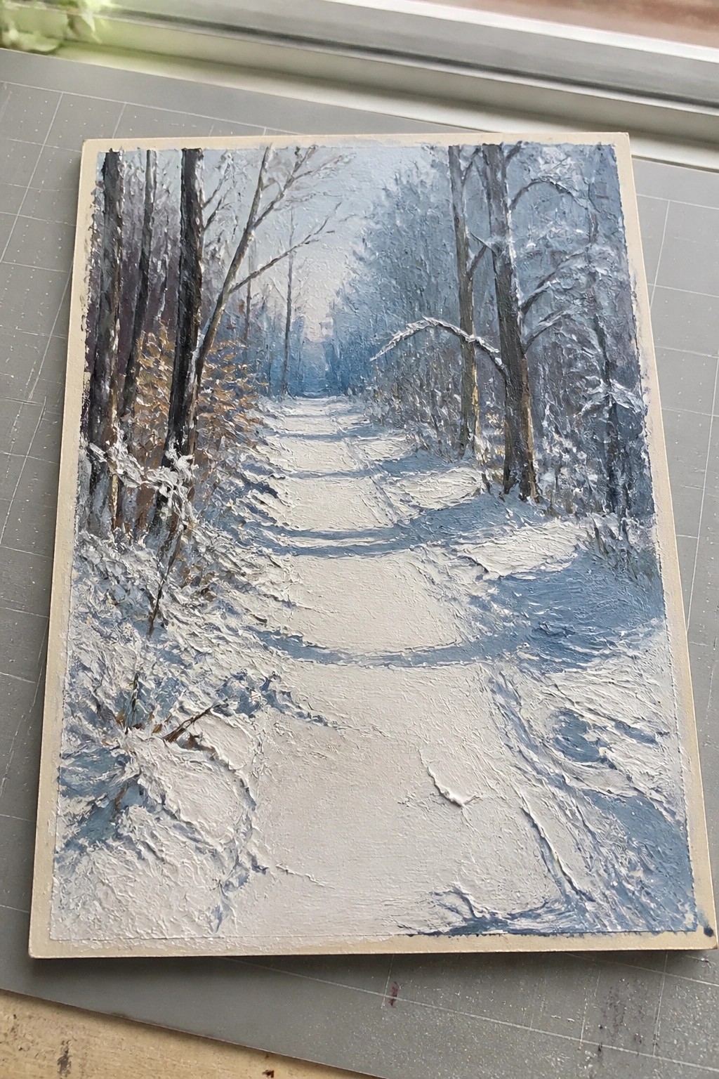Thickly textured oil painting of a winding snowy path through bare winter trees.