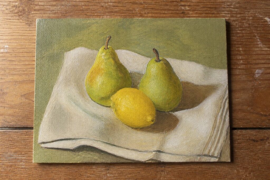 Still life painting of two pears and a lemon on draped cloth over wood