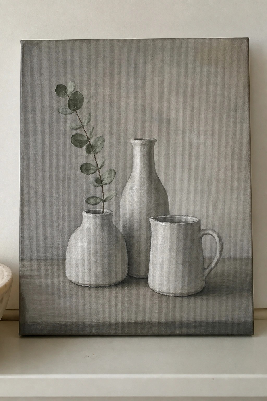 Gray still life painting of three ceramic vessels with eucalyptus branch