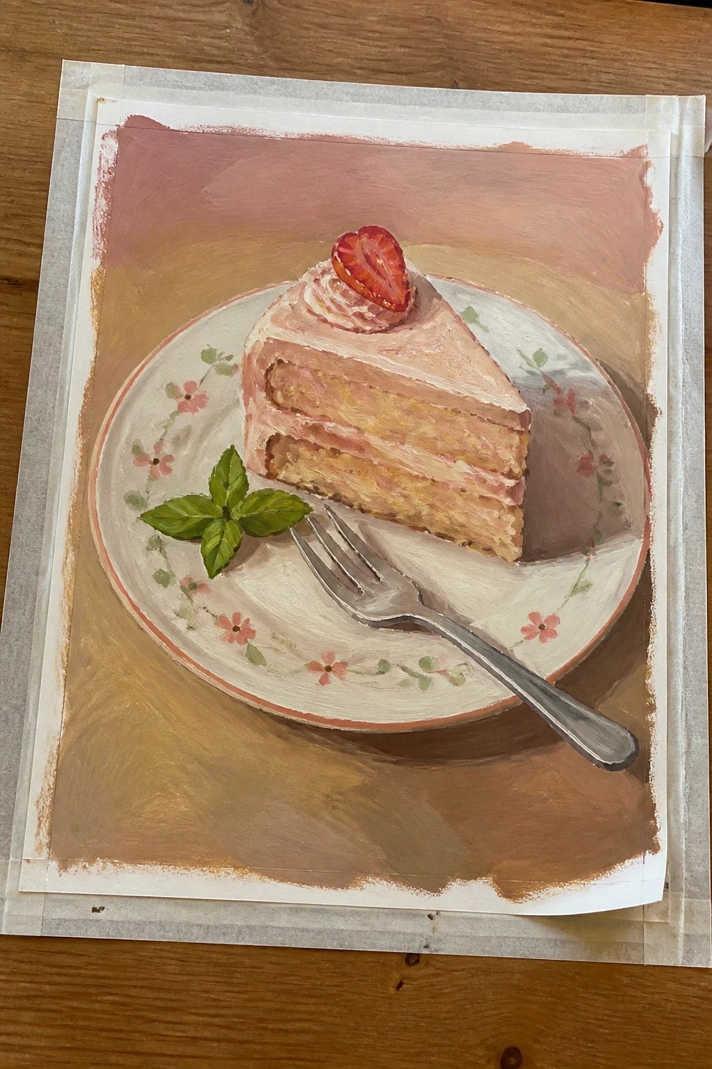 Pink strawberry cake slice on floral plate with fork and basil leaves