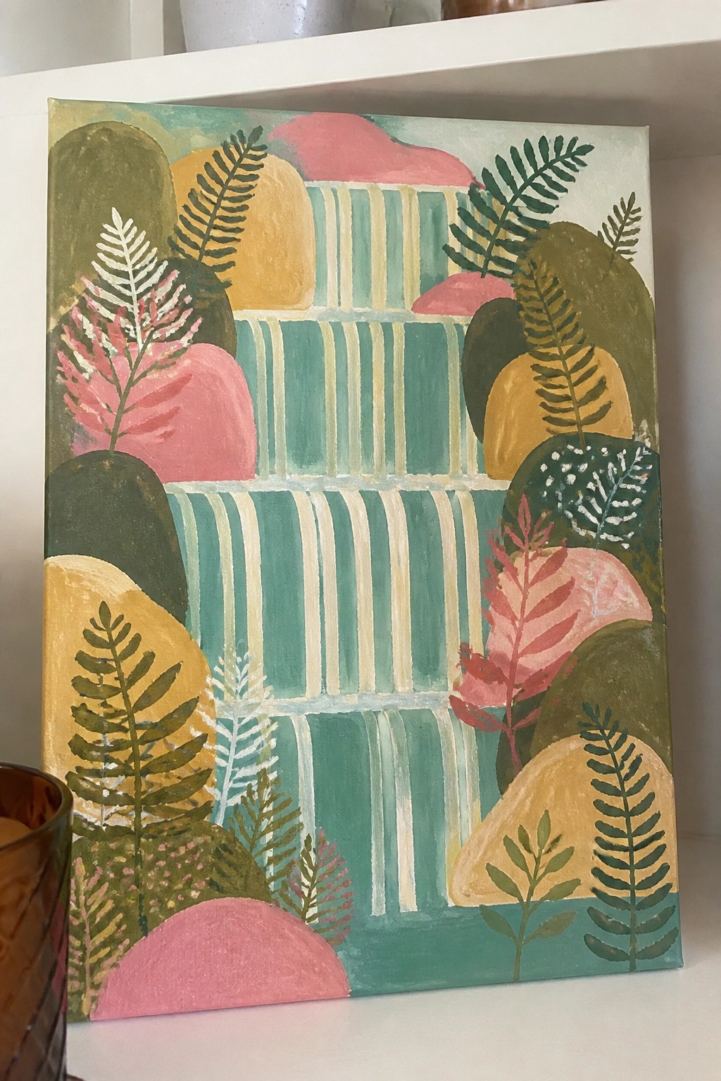 Abstract painting with pink rocks, green ferns, yellow shapes, and teal stripes